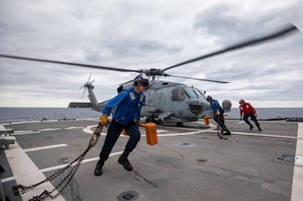 Sailors clear the flight deck during flight operations aboard USS Antietam (CG 54) in the Sea of Japan.