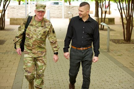 Jeremy Plumley (right), Military Intelligence Readiness Command sexual assault response coordinator, greets Maj. Gen. Eugene Leboeuf (left), U.S. Army Reserve Command deputy commanding general, walk together outside the Reserve Center in Austin, Texas, May 8, 2023.