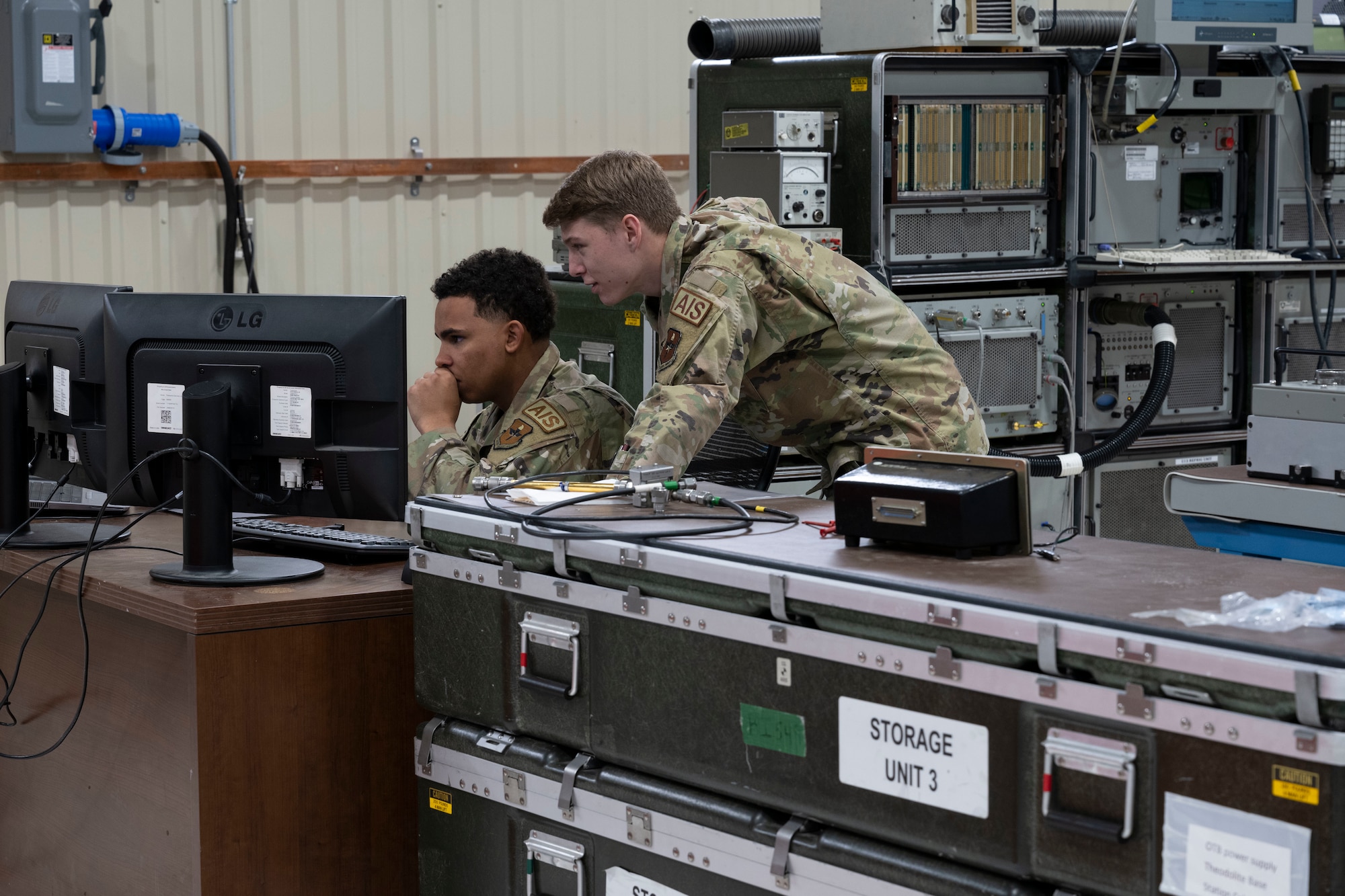 U.S. Air Force Airman 1st Class Brett McConell, left, and U.S. Air Force Airman 1st Class Nicholas Chamberlain, 49th Component Maintenance Squadron F-16 Viper avionics apprentices, monitor electronic technical orders to ensure all procedures are followed at Holloman Air Force Base, New Mexico, May 1, 2023. The 49th CMS avionics shop provides on and off-equipment maintenance support for assigned F-16 aircraft enabling pilot production. (U.S. Air Force photo by Airman 1st Class Michelle Ferrari)