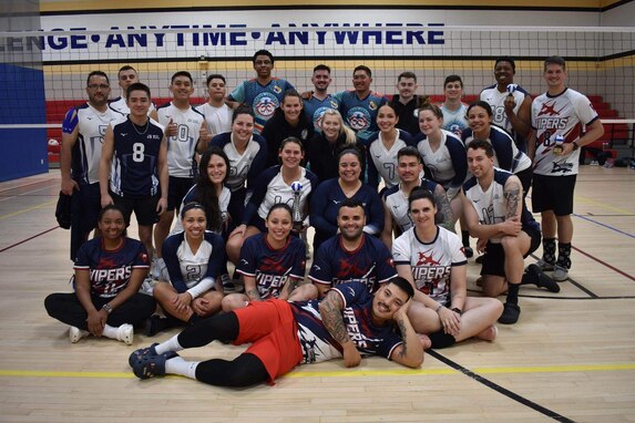 The Joint Base McGuire-Dix-Lakehurst travel volleyball team poses for a photo with members from Shaw Air Force Base and Seymour Johnson Air Force Base during volleyball tournament.
