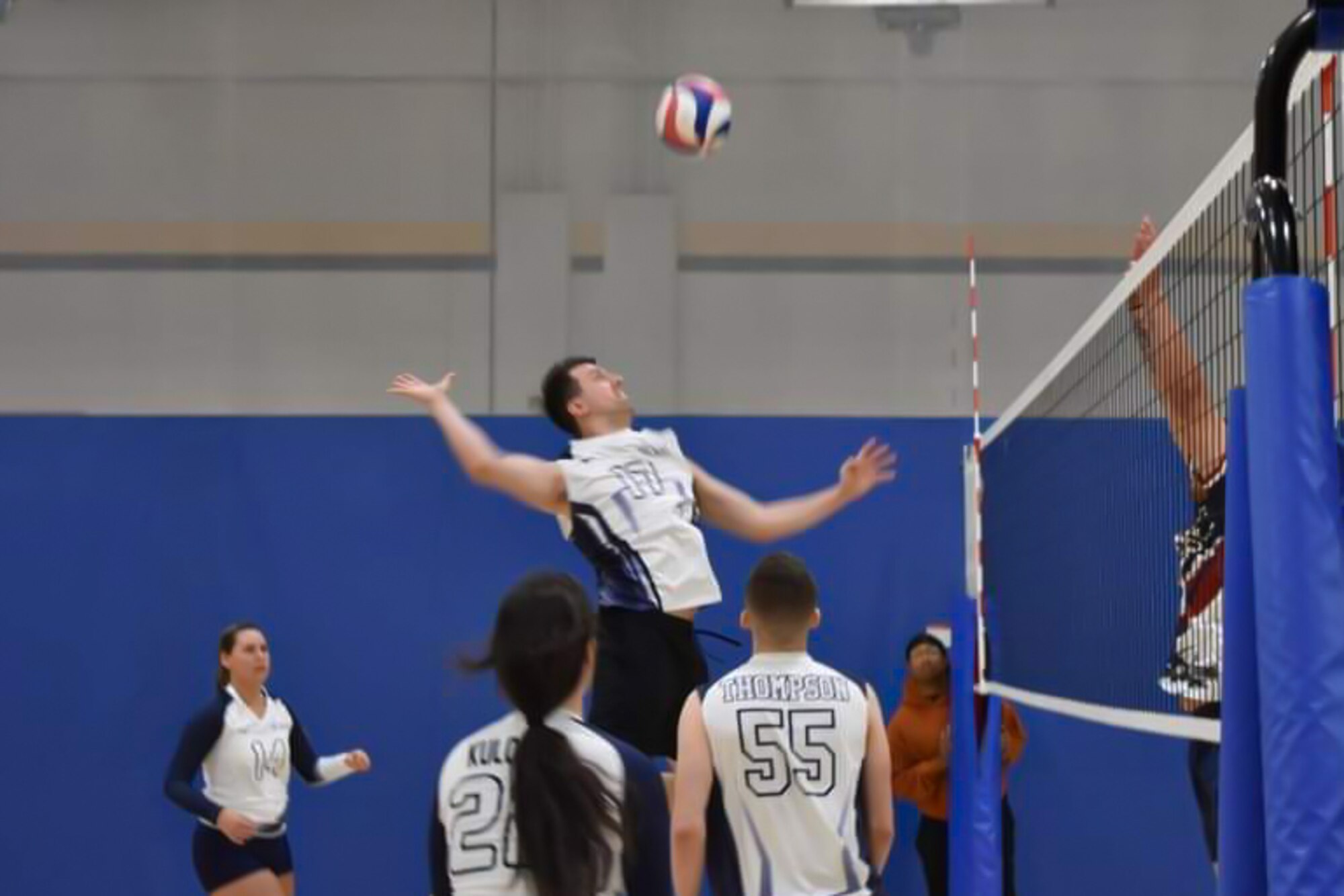 Joseph Germann spikes volleyball during tournament at Shaw Air Force Base.