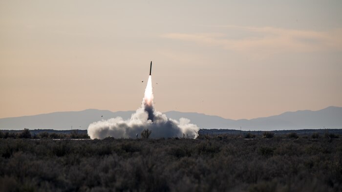 A U.S. Marine Corps M142 High Mobility Artillery Rocket System assigned to Kilo Battery, 2nd Battalion, 14th Marine Regiment, Marine Forces Reserve, fires a rocket while conducting a HIMARS rapid insertion training event during Weapons and Tactics Instructor course 2-22, Dugway Proving Ground, Utah, April 6, 2022. Kilo Battery conducted their annual training with WTI 2-22, enabling their Marines, and the aircrew training with WTI, to conduct a complex training evolution and certify that they are fully mission capable.