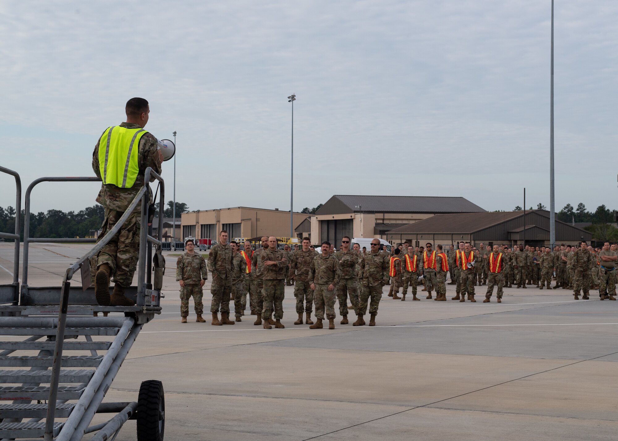 An Airman speaks to a crowd.