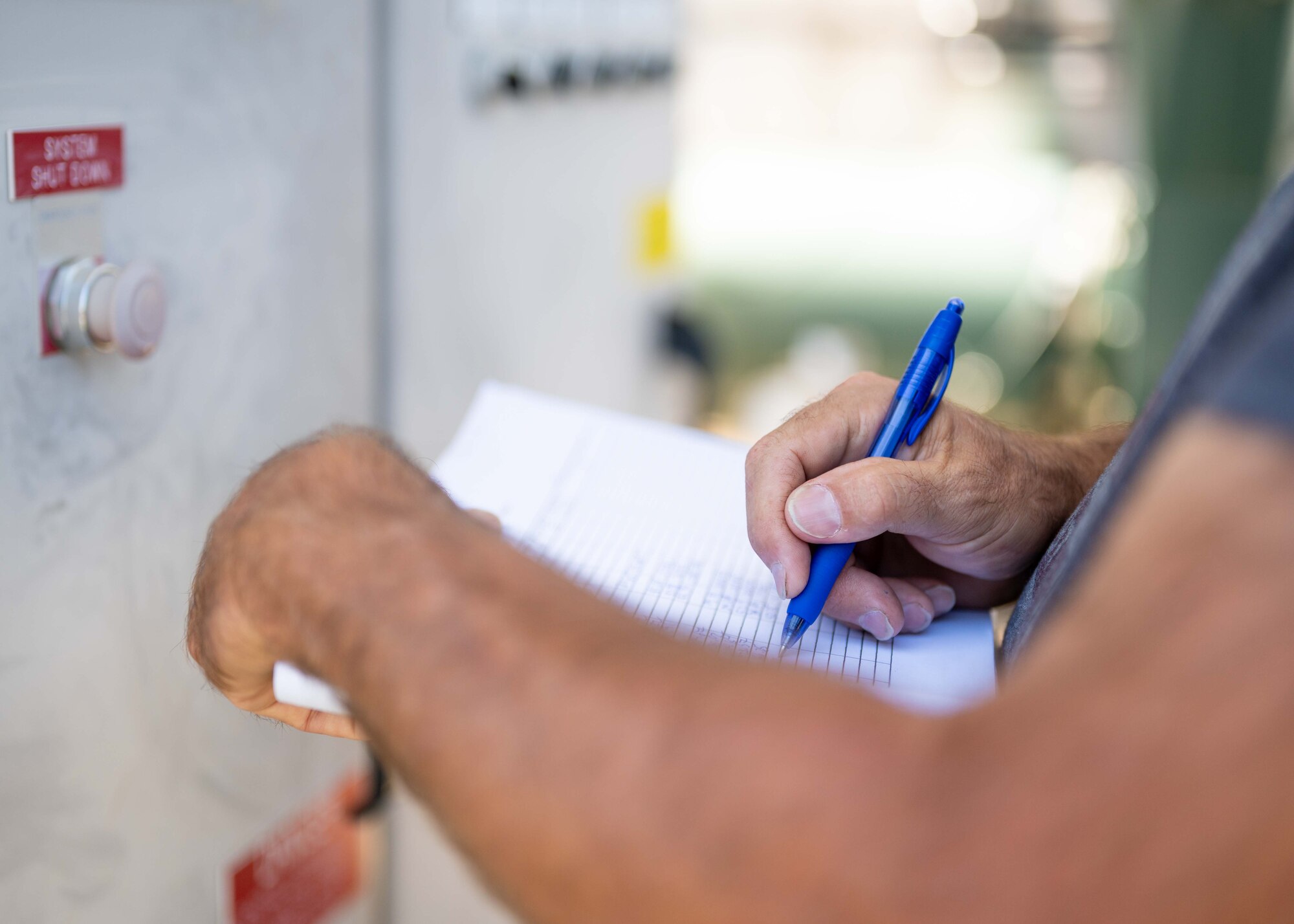 Kyle Dermantis notes the data about the groundwater treatment progress on a notepad.