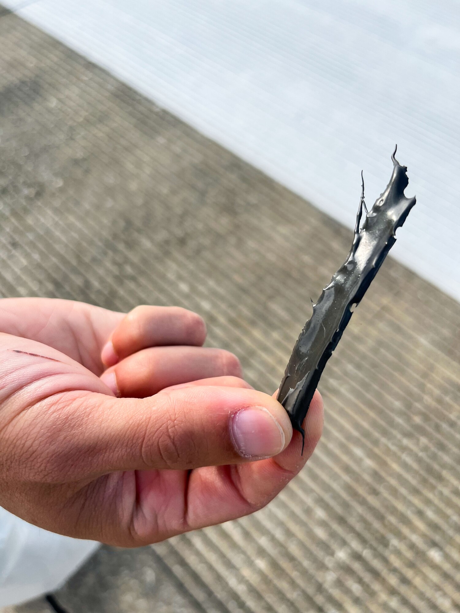 And Airman holds up a piece of debris.