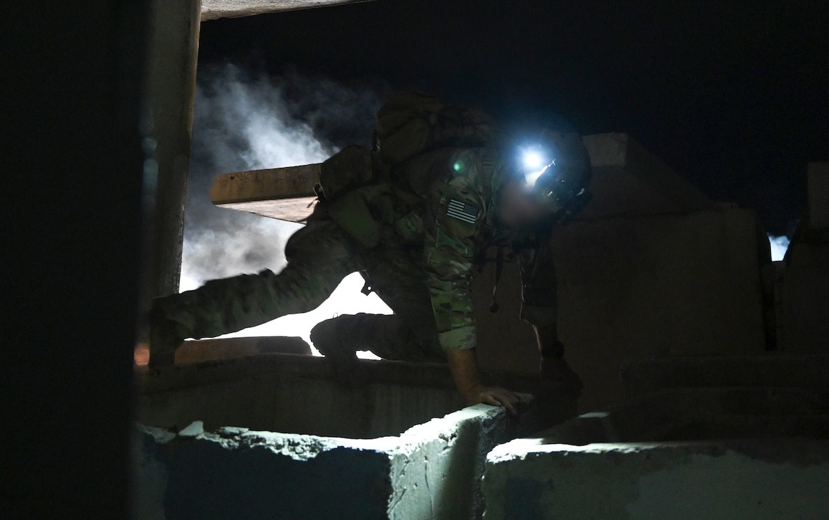 A U.S. Special Tactics operator, assigned to the 24th Special Operations Wing, searches a simulated collapsed structure for survivors during mass casualty training as part of Emerald Warrior 23 on Camp Santiago, Puerto Rico on May 1, 2023.