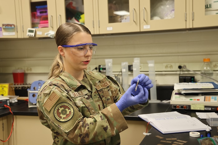 2nd Lt. Evon Delisle, a Biomaterials Research Scientist, prepares muskox guard hair samples to test their break force, or load that the material can sustain before breaking, in the Air Force Research Laboratory, or AFRL, Biomaterials Laboratory of the Materials and Manufacturing Directorate, Wright-Patterson Air Force Base, Ohio, May 12, 2023. Researchers involved in this facet of the muskox wool keratin fiber project seek correlations between animal age, fiber diameter and break force, and examine how those characteristics are associated with different keratin genes. (U.S. Air Force photo / Jonathan Taulbee)
