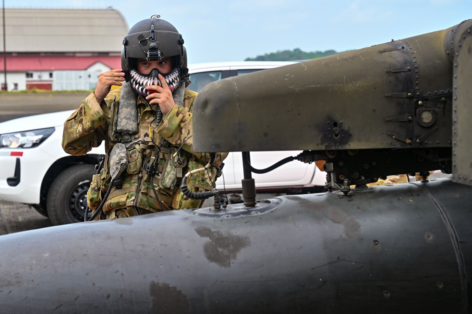 U.S. Army Sgt. Tucker Sarkissian, 1st Battalion, 228th Aviation Regiment UH-60 Black Hawk crew chief, affixes his helmet mandible guard prior to takeoff at the Panama Pacific International Airport May 6, 2023.