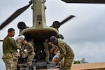 Members of Panama’s Servicio Nacional de Fronteras (SENAFRONT) transfer cargo from a CH-47 Chinook assigned to the 1st Battalion, 228th Aviation Regiment as part of exercise Keel Billed Toucan 2023 (known locally as Mercurio V) at a remote location in Panama, May 7, 2023. Since the 1980s, exercises like KBT 23 give Joint Task Force-Bravo, based in Honduras, opportunities to hone its humanitarian assistance and disaster relief skills by working with regional partners, while also providing aid to remote areas across Central America.(U.S. Air Force photo by Tech. Sgt. Duncan McElroy)