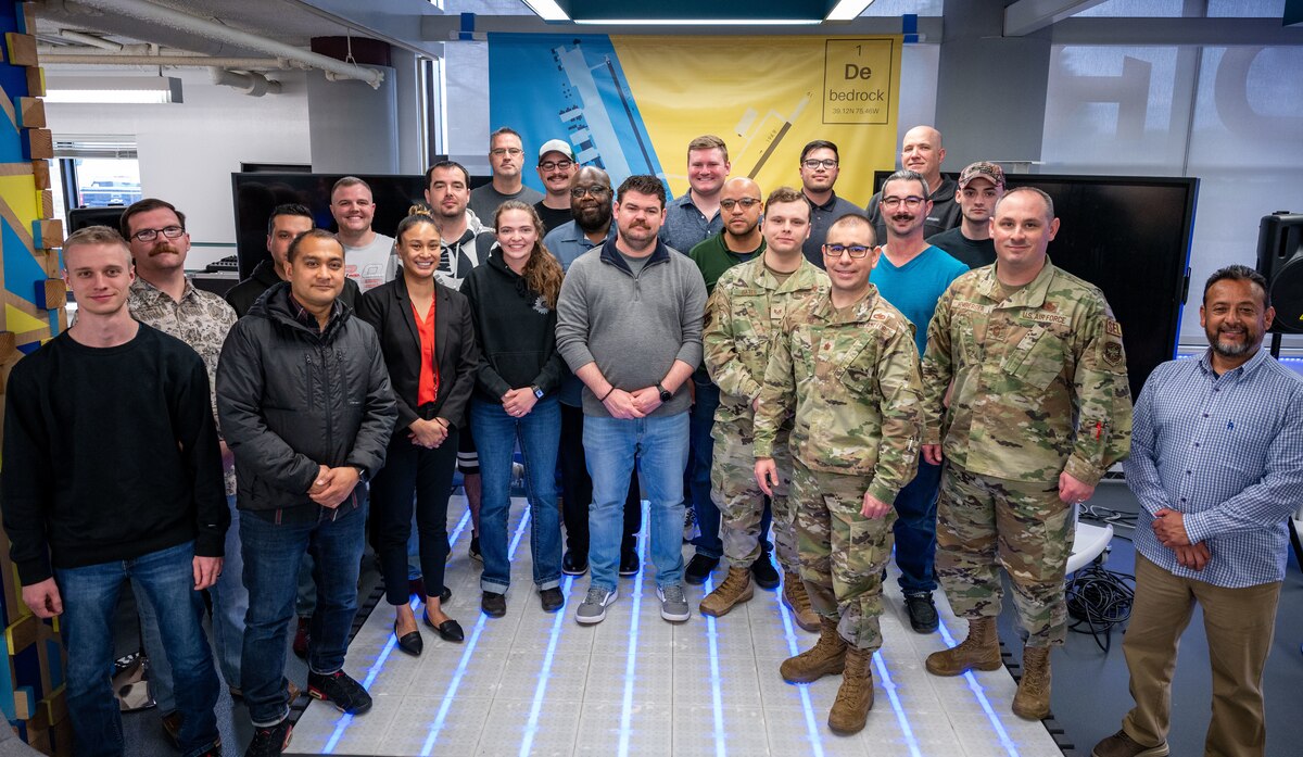 A group of Dover Air Force Base maintenance Airmen and Boeing representatives pose for a group photo at Bedrock Innovation Lab on Dover Air Force Base, Delaware, April 7, 2023. Boeing representatives and Dover AFB Airmen partnered for a week-long collaboration to discuss improvements for home station checks. (U.S. Air Force photo by Airman 1st Class Amanda Jett)