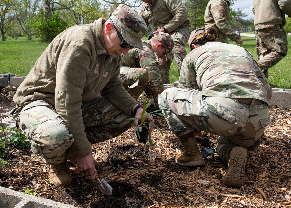 Airmen add plants to the garden during the Butterfly Garden beautification May 03, 2023, at Wright-Patterson Air Force Base, Ohio. The pollinator garden provides a memorial space for parents who have experienced the loss of a pregnancy or child.  (U.S. Air Force photo by Airman 1st Class Elizabeth Figueroa)