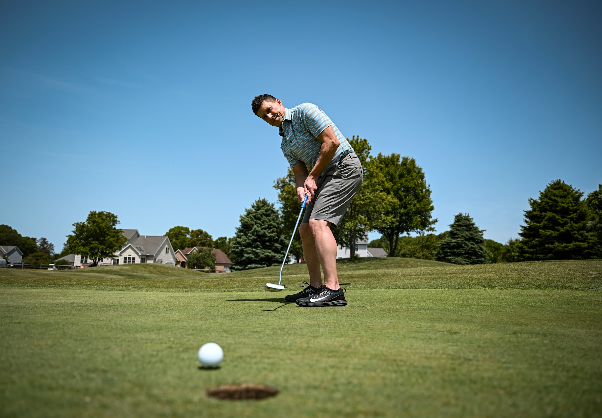 A participant putts a golf ball during the Bluesuiters Golf Tournament at Jonathan’s Landing Golf Course in Magnolia, Delaware, May 11, 2023. Bluesuiters is a biannual golf tournament aimed at connecting Team Dover Airmen with local civic and business leaders. (U.S. Air Force photo by Staff Sgt. Marco A. Gomez)