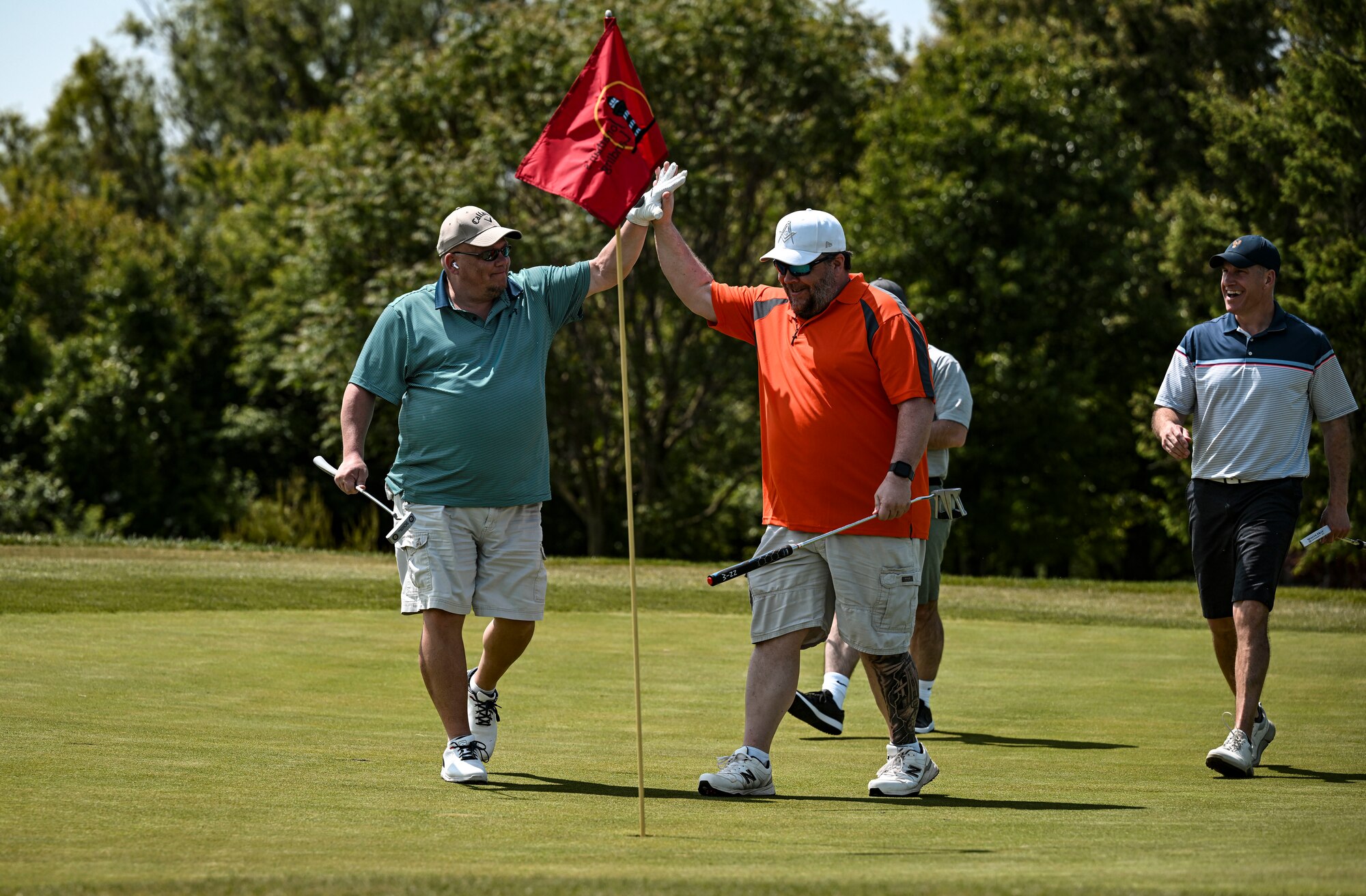 A group of participants celebrate during the Bluesuiters Golf Tournament at Jonathan’s Landing Golf Course in Magnolia, Delaware, May 11, 2023. The tournament sponsors Dover Air Force Base Airmen twice a year, matching them with local Chamber of Commerce members. The tournament provided Airmen an opportunity to engage in team-building activities and network. (U.S. Air Force photo by Staff Sgt. Marco A. Gomez)