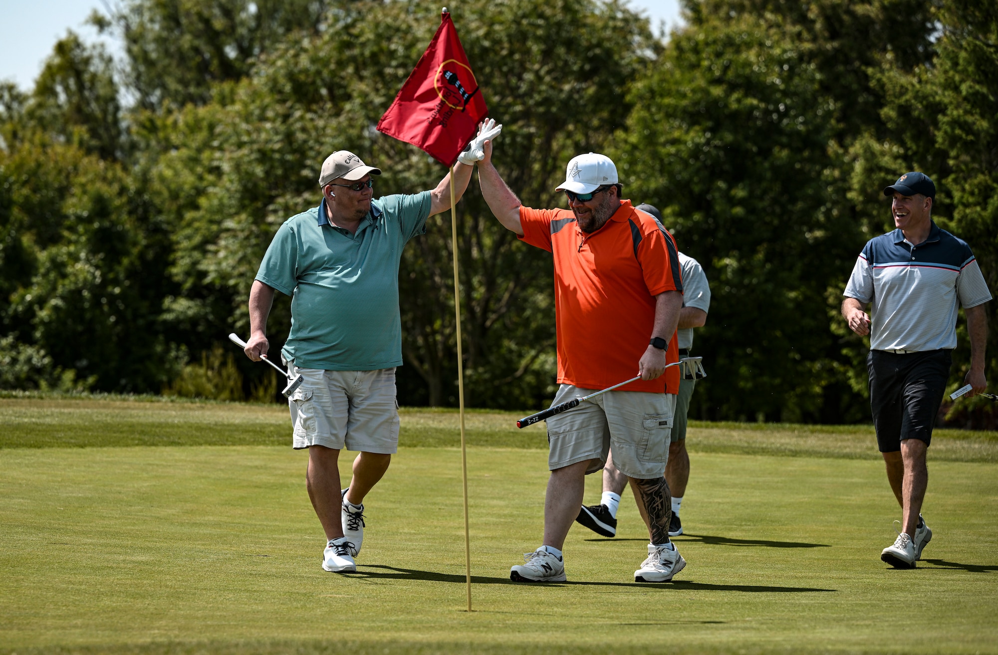 A group of participants celebrate during the Bluesuiters Golf Tournament at Jonathan’s Landing Golf Course in Magnolia, Delaware, May 11, 2023. The tournament sponsors Dover Air Force Base Airmen twice a year, matching them with local Chamber of Commerce members. The tournament provided Airmen an opportunity to engage in team-building activities and network. (U.S. Air Force photo by Staff Sgt. Marco A. Gomez)