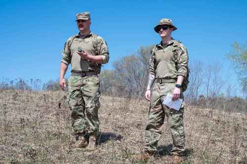 Senior Airman Tucker Lemmerman, left, and Senior Airman Avery Tillery, both 934th Security Forces Squadron specialists, check their surroundings during a land navigation course at Arden Hills, Minnesota, May 7, 2023. The 934 SFS conducted a routine land navigation course to refresh and brush up on the arduous process of using a compass and pace count. (U.S. Air Force photo by Senior Airman Matthew Reisdorf)
