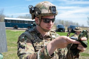 Staff Sgt. Ian Reynolds, a 934th Security Forces Squadron specialist, plots a path using a compass at Arden Hills, Minnesota, on May 7, 2023. The 934 SFS conducted a routine land navigation course to refresh and brush up on the arduous process of using a compass and pace count. (U.S. Air Force photo by Senior Airman Matthew Reisdorf)
