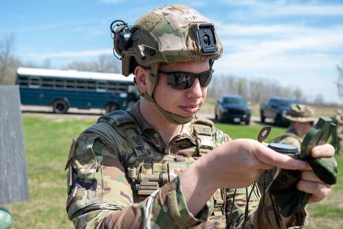 Staff Sgt. Ian Reynolds, a 934th Security Forces Squadron specialist, plots a path using a compass at Arden Hills, Minnesota, on May 7, 2023. The 934 SFS conducted a routine land navigation course to refresh and brush up on the arduous process of using a compass and pace count. (U.S. Air Force photo by Senior Airman Matthew Reisdorf)