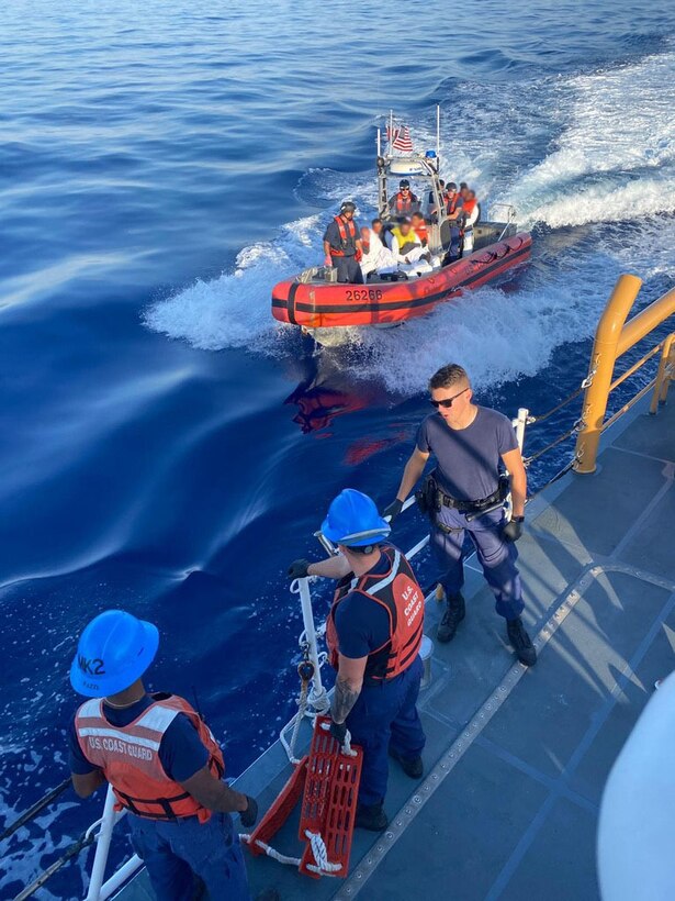 Crews aboard Coast Guard Cutter Manowar receive 18 migrants from Coast Guard Cutter Richard Etheridge April 11, 2023, after being interdicted approximately 28 miles off the coast of Fort Pierce Inlet, Florida. The migrants were repatriated to their country of departure, Freeport, Bahamas. (U.S. Coast Guard courtesy photo)