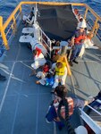 Crews aboard Coast Guard Cutter Manowar receive 18 migrants from Coast Guard Cutter Richard Etheridge April 11, 2023, after being interdicted approximately 28 miles off the coast of Fort Pierce Inlet, Florida. The migrants were repatriated to their country of departure, Freeport, Bahamas. (U.S. Coast Guard courtesy photo)