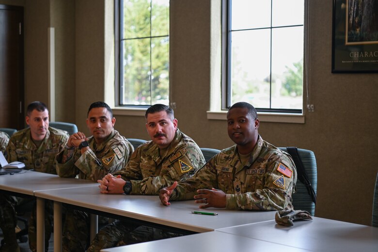 U.S. Space Force Baron Drinks, 30th Space Communications Squadron non-commissioned officer in charge of cable and antenna maintenance, addresses the class during the first-ever Basic Enlisted Strategic Thinking joint professional development course at the Vandenberg Space Force Base Education Center from May 8-12, 2023. Fourteen Air and Space Force non-commissioned officers attended the joint professional development course and learned about critical and strategic thinking. (U.S. Space Force photo by Senior Airman Tiarra Sibley)