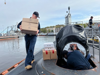 Sailors assigned to the Virginia-class fast-attack submarine USS California (SSN 781) onload supplies as the boat gets underway as part of Exercise Agile Player 2023 (AP23) at Naval Submarine New London in Groton, Connecticut, May 3, 2023.