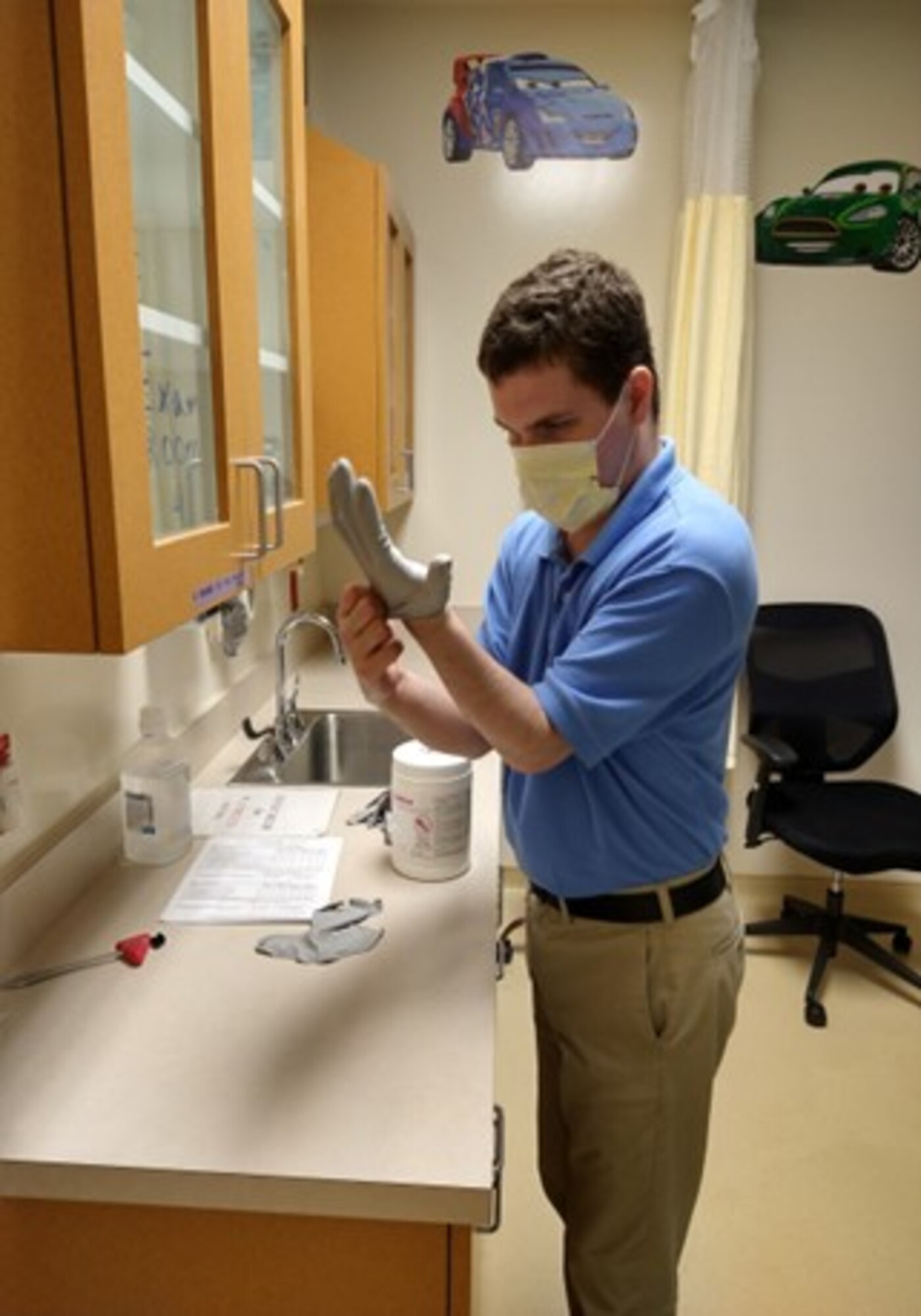 Courtesy photo of Andrew Norton, Project SEARCH intern, working in a medical examination room at the 81st Medical Group.