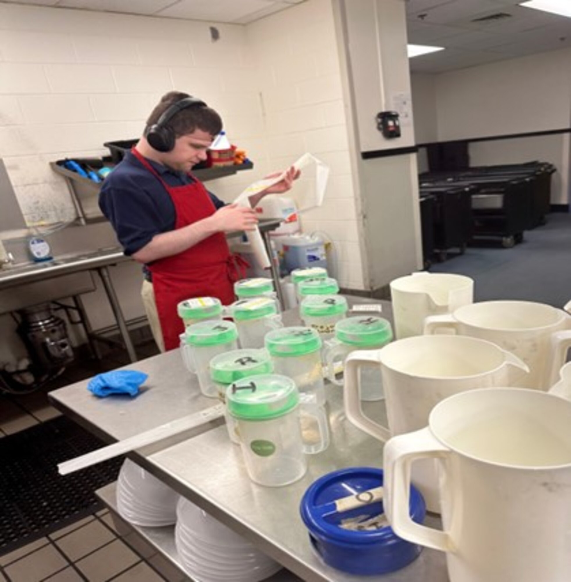 Courtesy photo of Andrew Norton, Project SEARCH intern, working in the kitchen at the Keesler Air Force Base Child Development Center.