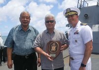 Cmdr. Leif Gunderson (right), commanding officer of the Arleigh Burke-class guided-missile destroyer USS Milius (DDG 69), presents a plaque to Arnold Palacios (center), governor of the Commonwealth of the Northern Mariana Islands, and David Apatang (left), lieutenant governor of the Commonwealth of the Northern Mariana Islands, during a scheduled port visit. Milius is assigned to Commander, Task Force 71/Destroyer Squadron (DESRON) 15, the Navy’s largest forward-deployed DESRON and the U.S. 7th Fleet’s principal surface force.