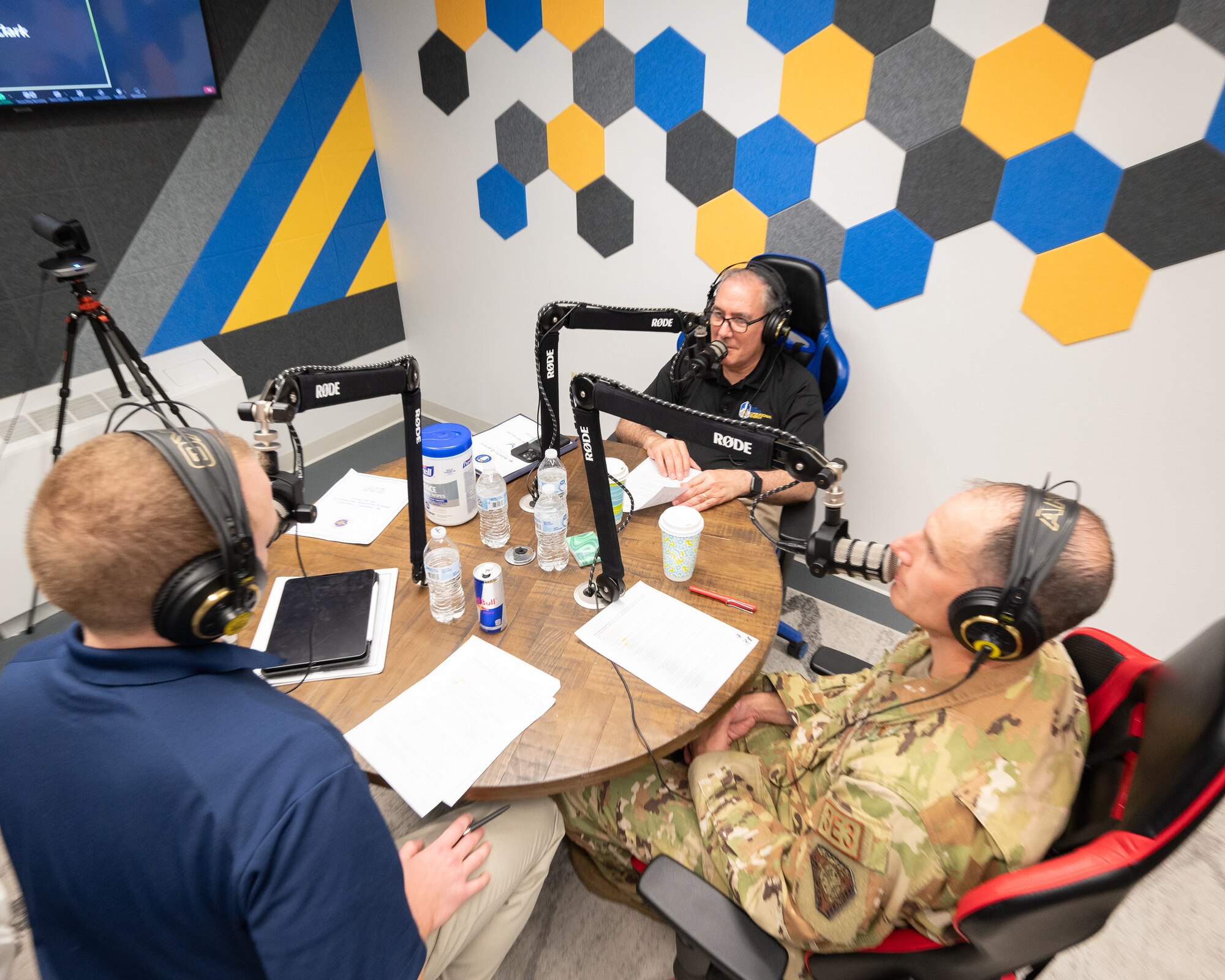 Roberto Guerrero, Deputy Assistant Secretary of the Air Force, speaks on a podcast with Col. Matt Husemann, 436th Airlift Wing commander, and Capt. Matt Figliotti, Bedrock Innovation Lab deputy chief innovation officer, at Dover Air Force Base, Delaware, May 7, 2023. Guerrero toured various units to help identify obstacles associated with everyday logistical tasks vital to combat mission accomplishment. (U.S. Air Force photo by Mauricio Campino)