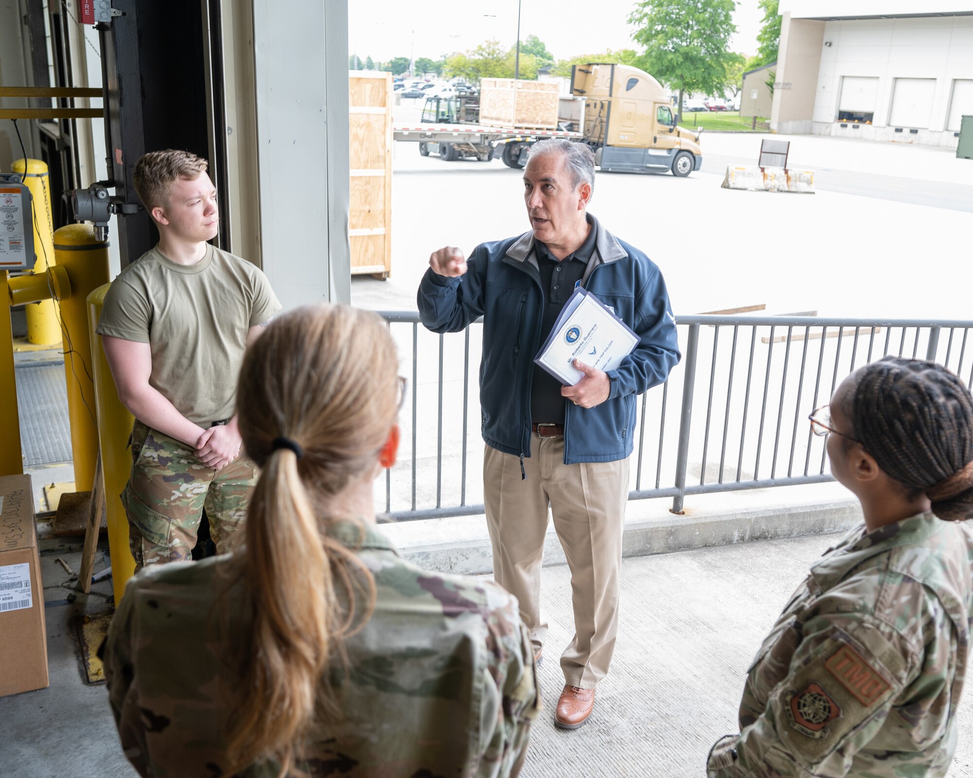 Roberto Guerrero, Deputy Assistant Secretary of the Air Force, speaks with 436th Aerial Port Squadron Airmen at Dover Air Force Base, Delaware, May 7, 2023. Guerrero toured various units to help identify obstacles associated with everyday logistical tasks vital to combat mission accomplishment. (U.S. Air Force photo by Mauricio Campino)