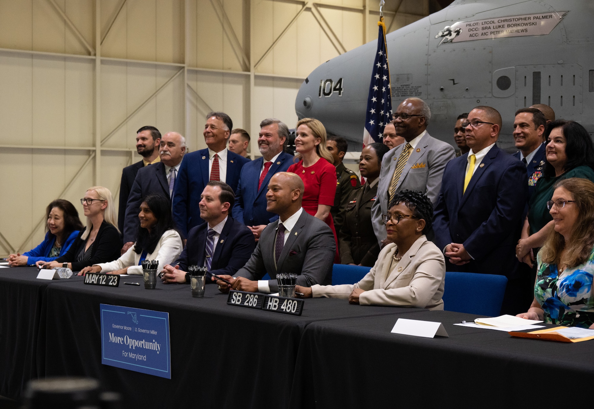 Maryland National Guard leadership present Maryland Gov. Wes Moore a photo of A-10C Thunderbolt II aircraft on the flight line and a flight jacket after a bill signing event at the 175th Wing, Maryland Air National Guard at Martin State Air National Guard Base, Middle River, Maryland, May 12, 2023.