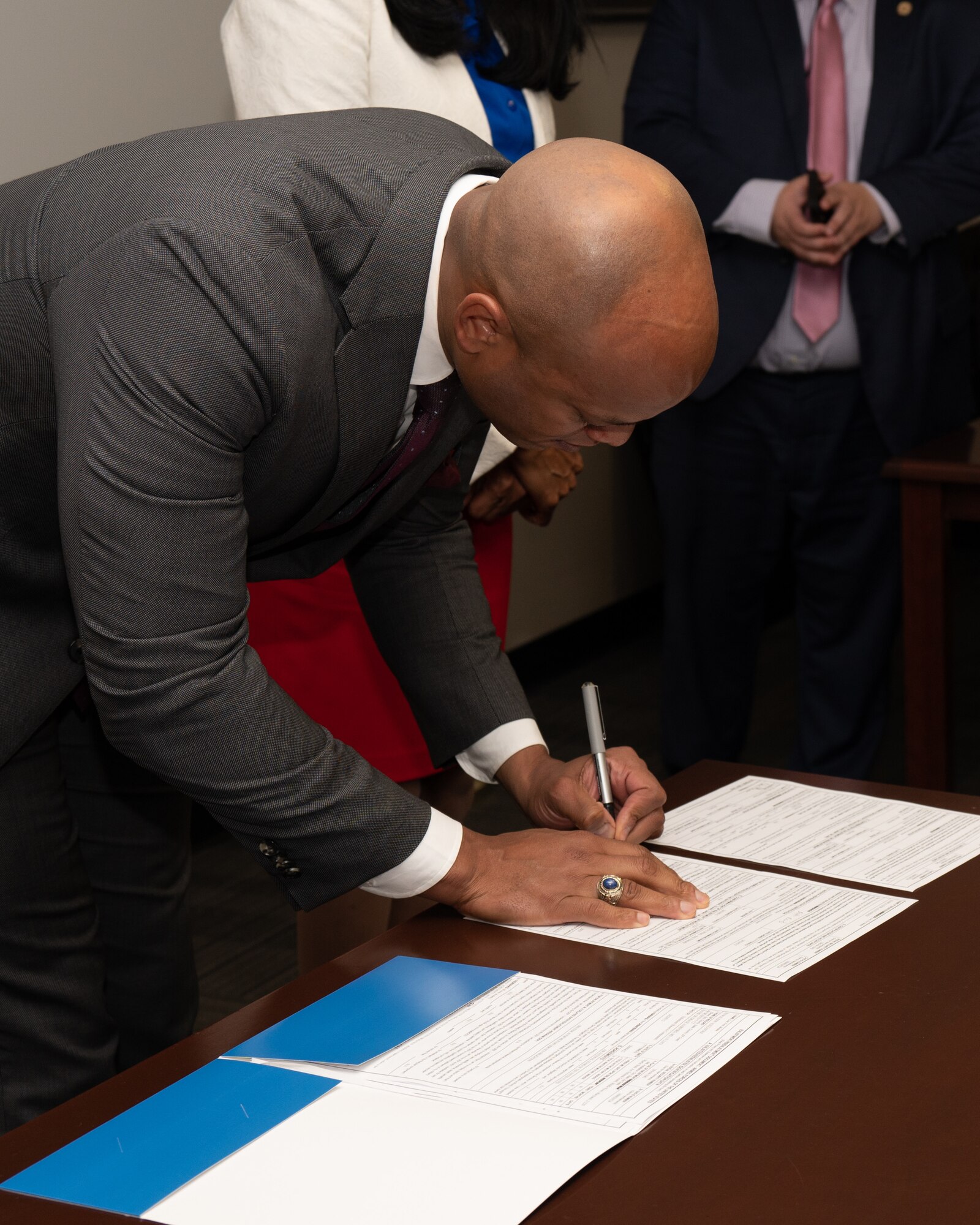 Maryland National Guard leadership present Maryland Gov. Wes Moore a photo of A-10C Thunderbolt II aircraft on the flight line and a flight jacket after a bill signing event at the 175th Wing, Maryland Air National Guard at Martin State Air National Guard Base, Middle River, Maryland, May 12, 2023.