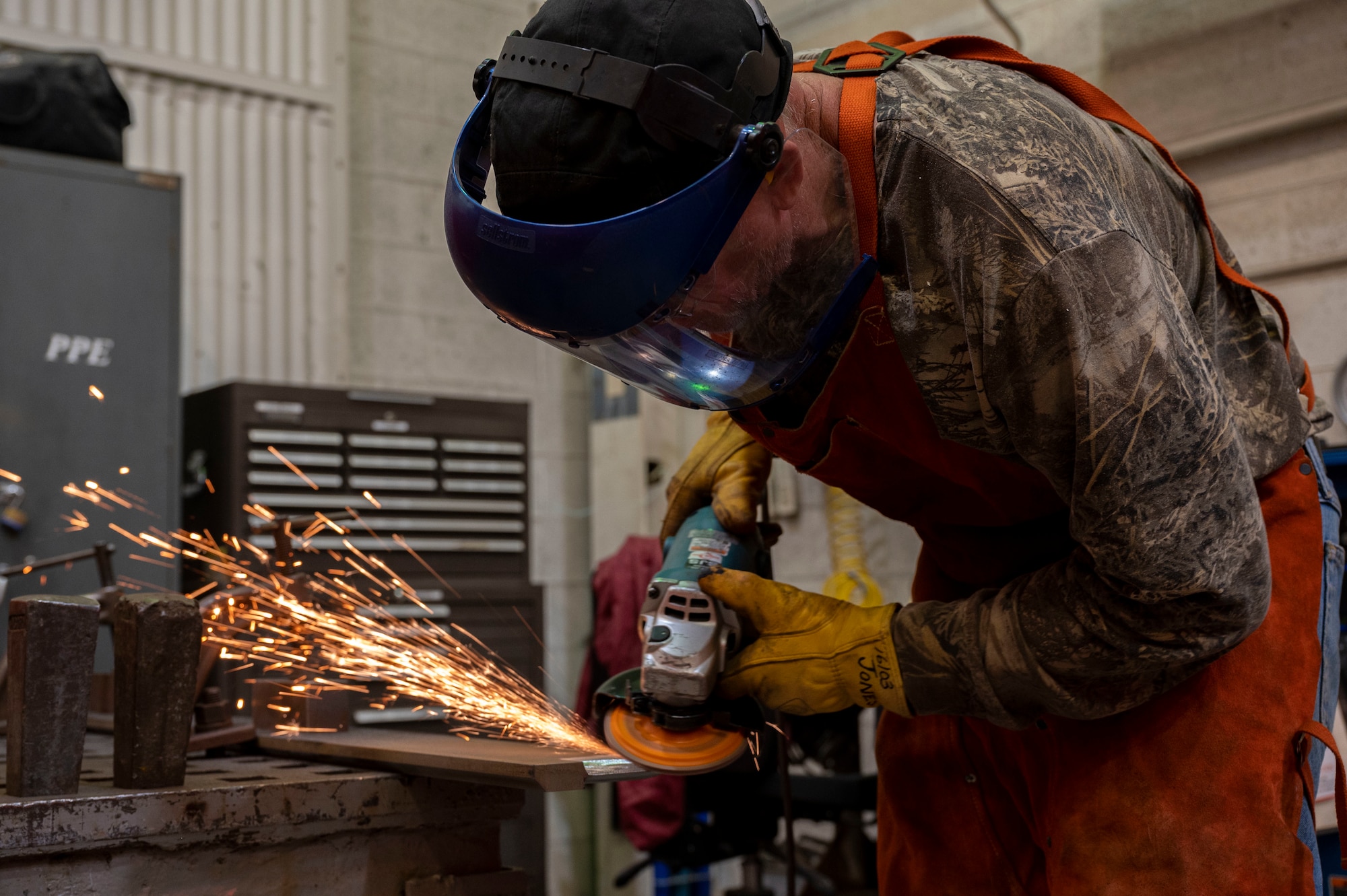 Brian Jones, 846th Test Squadron welder, scrapes down a piece of metal at Holloman Air Force Base, New Mexico, May 9, 2023.