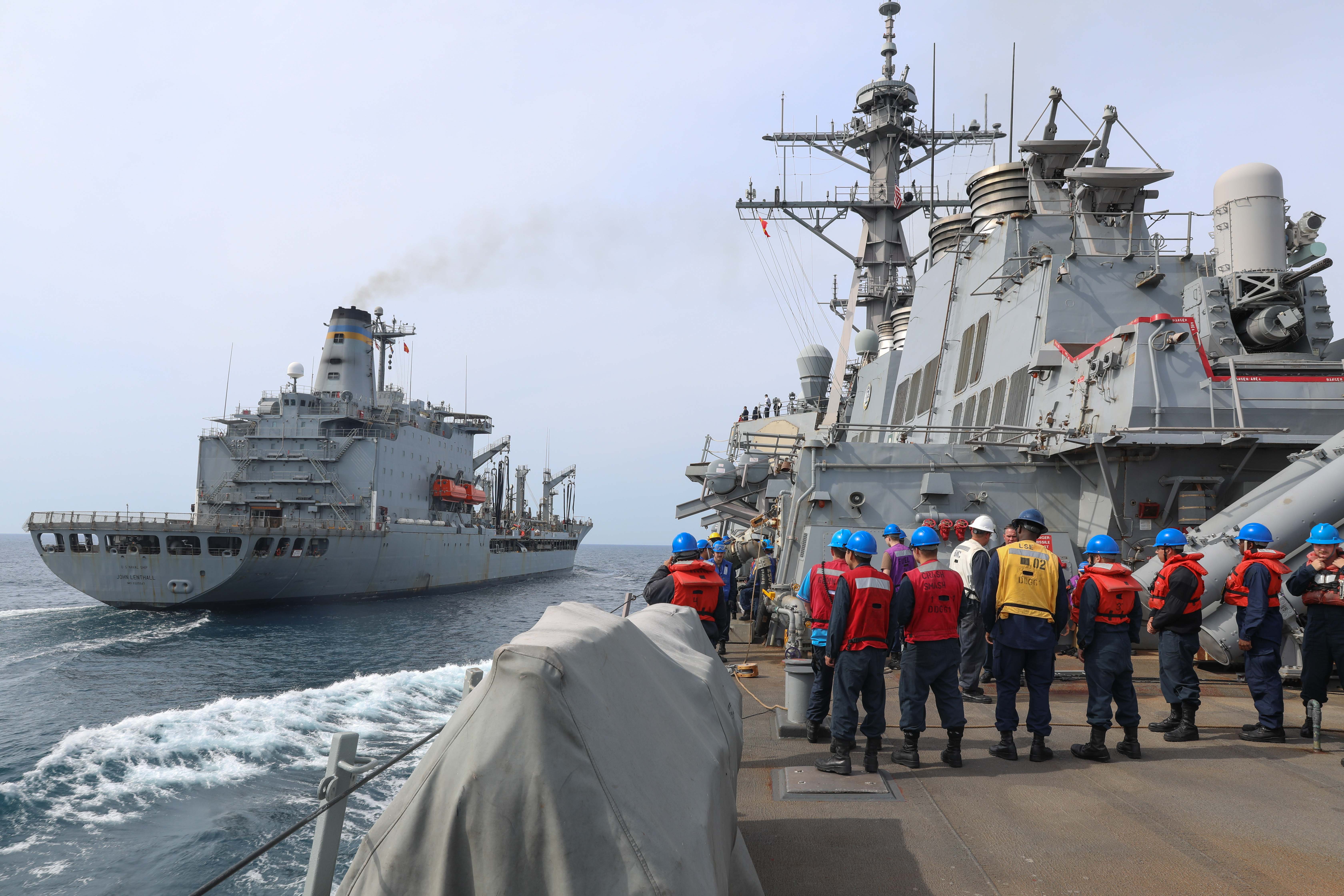Sailors aboard USS Ramage (DDG 61) prepare for an underway replenishment with USNS John Lenthall.