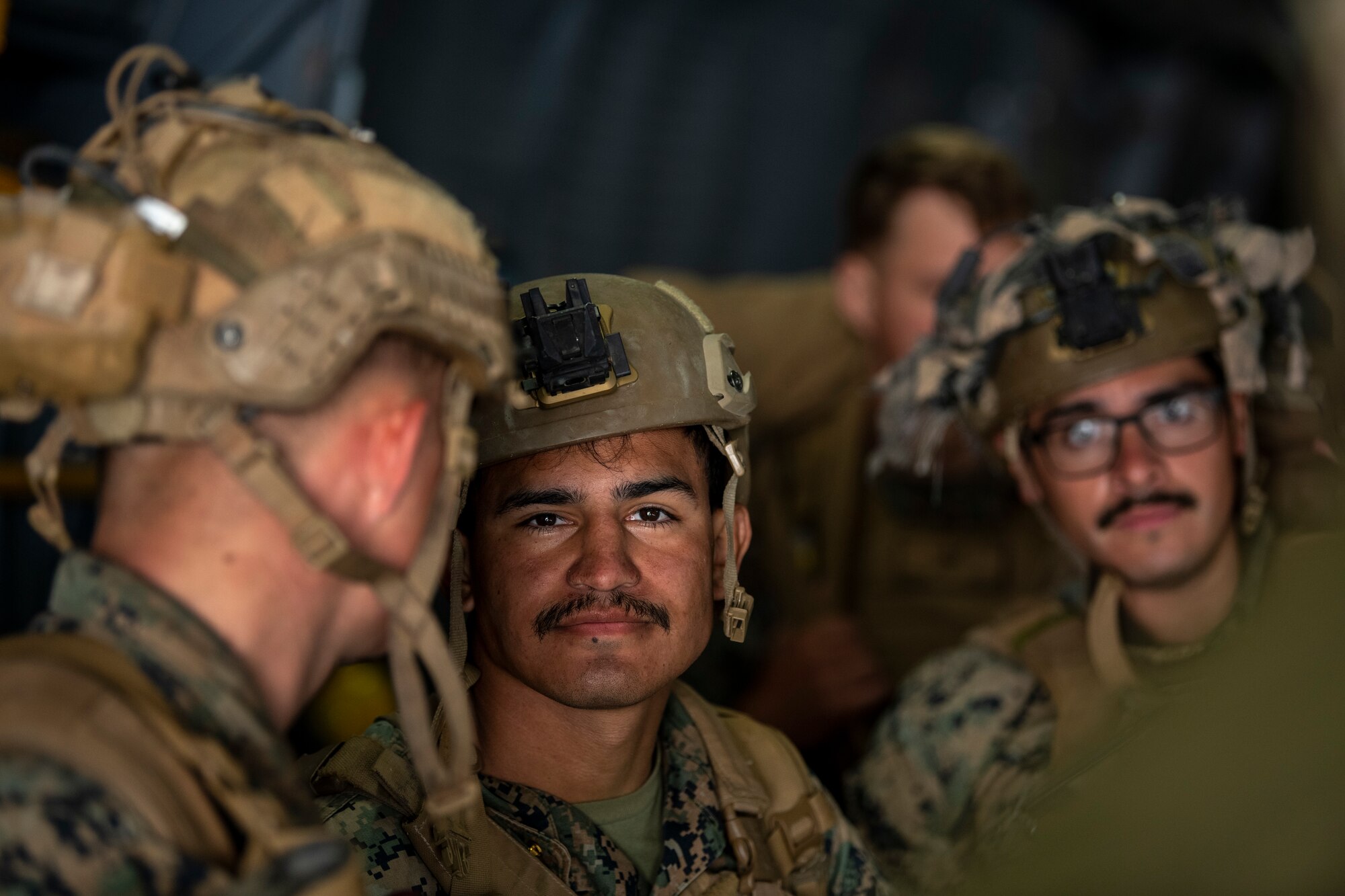 Men stand inside a large military aircraft