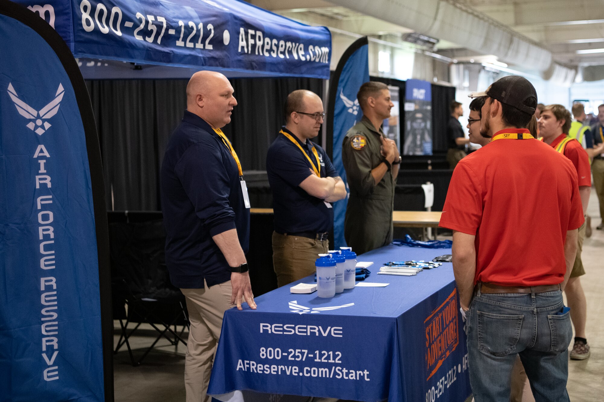Reserve recruiters engage with collegiate aviators at a recruiting booth