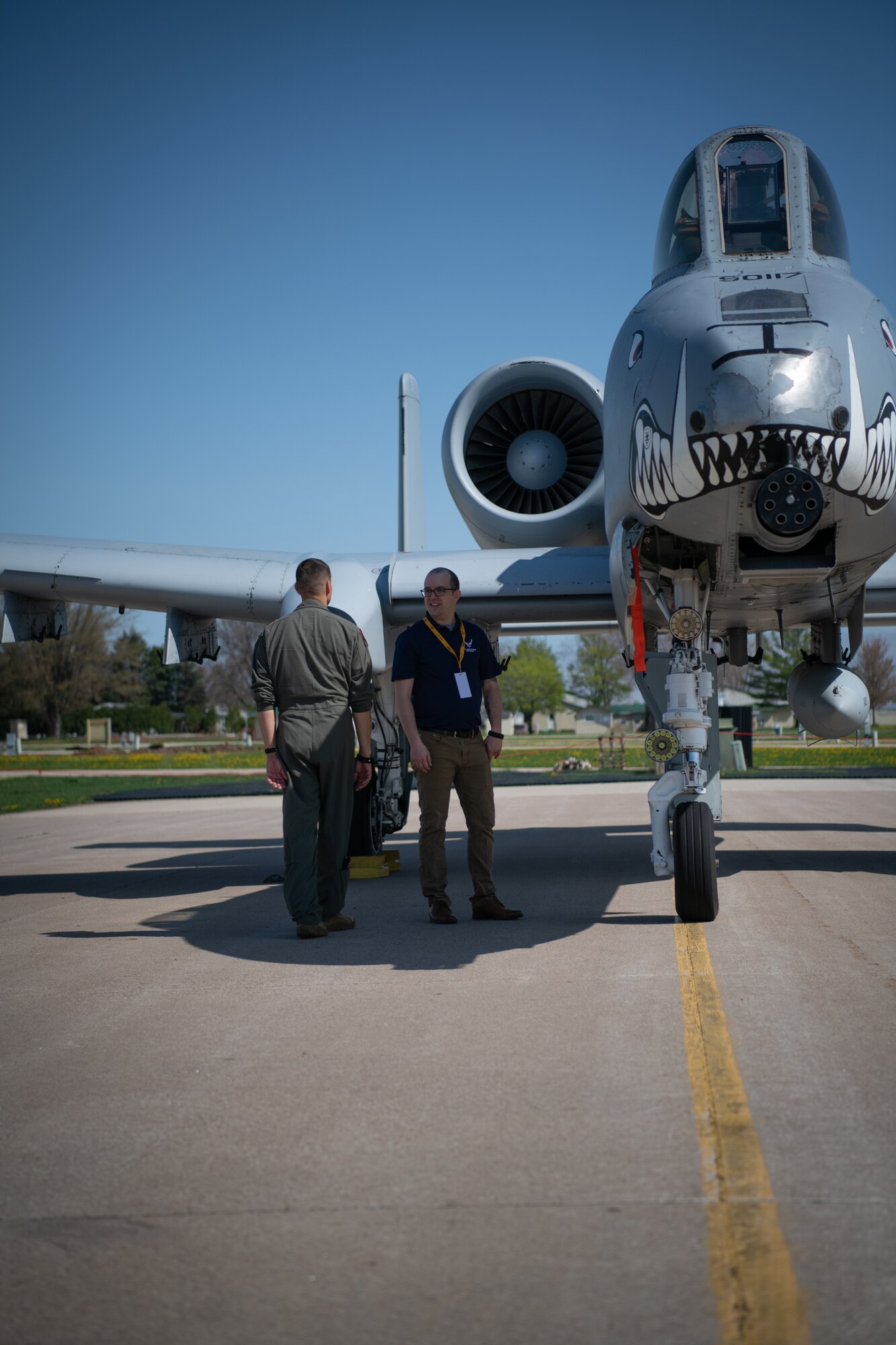 Two Airmen conduct a tour of an A-10 "Warthog" aircraft