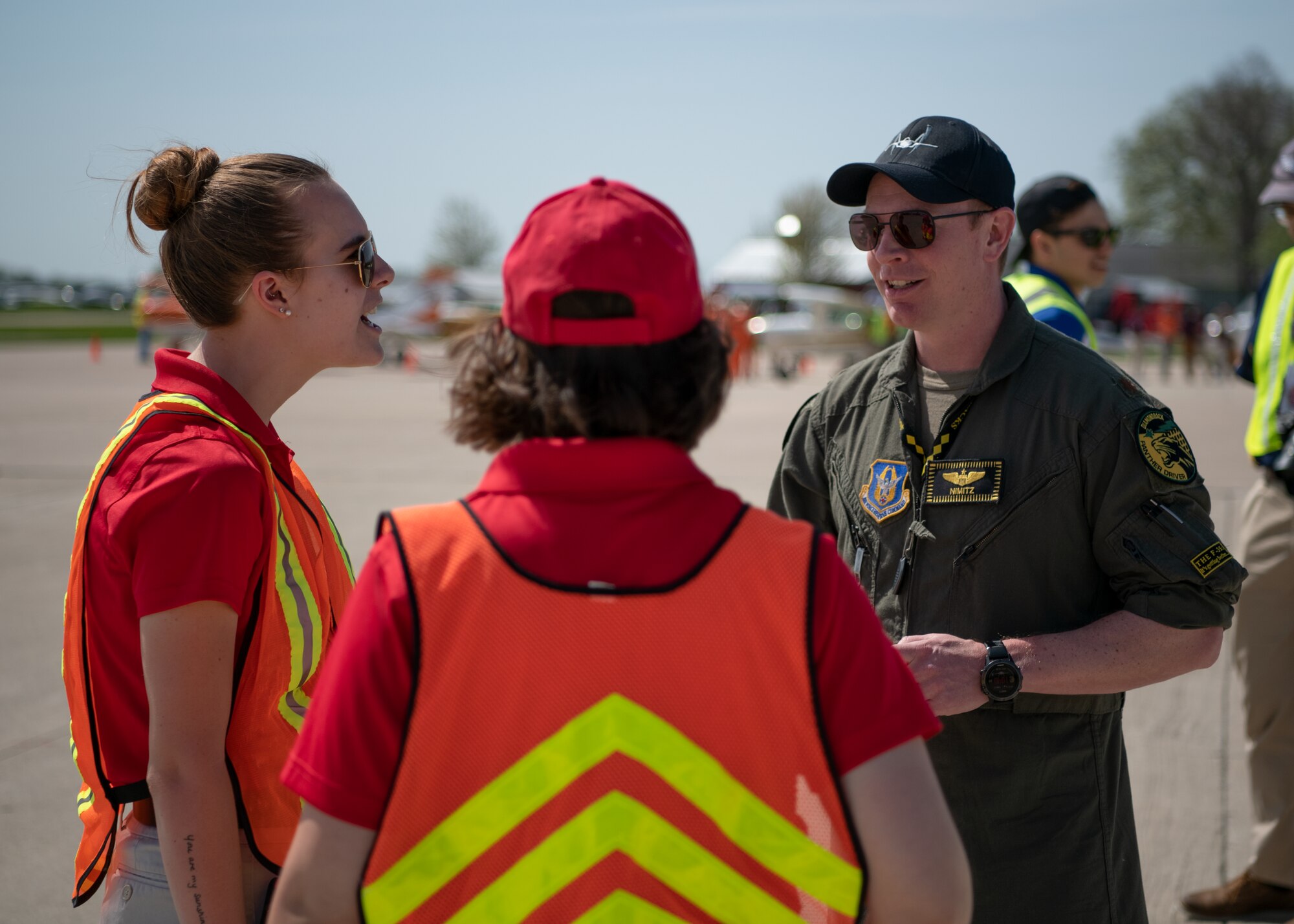 A pilot talks to collegiate aviators on a flight line