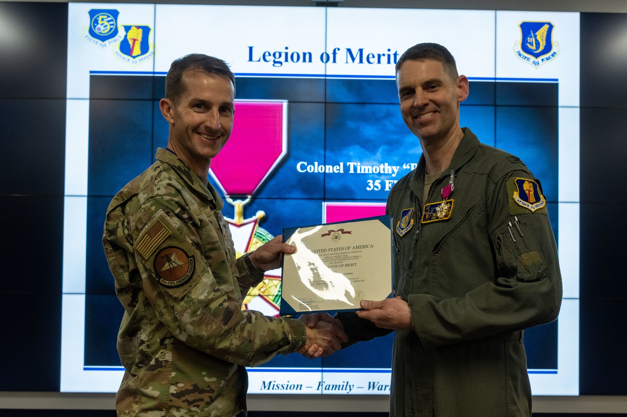 U.S. Air Force Col. Michael Richard, 35th Fighter Wing (FW) commander, presents Col. Timothy Murphy, 35th FW vice commander, a Legion of Merit medal at Misawa Air Base, Japan, May 4, 2023.