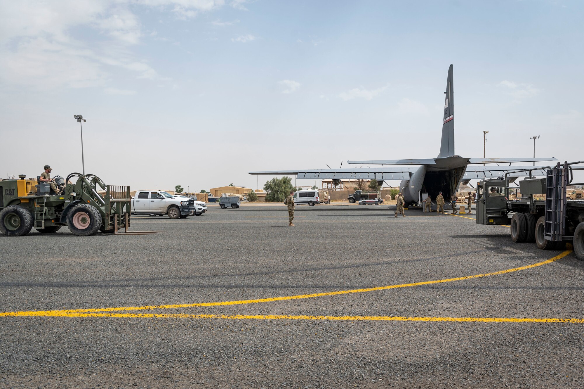 U.S. Air Force Airmen from the 386th Expeditionary Logistics Readiness Squadron and the 40th Expeditionary Airlift Squadron prepare to load a forklift and pallets on to a C-130J Super Hercules during the exercise Operation Agile Marauder 23.1 at Ali Al Salem Air Base, Kuwait, May 11, 2023.