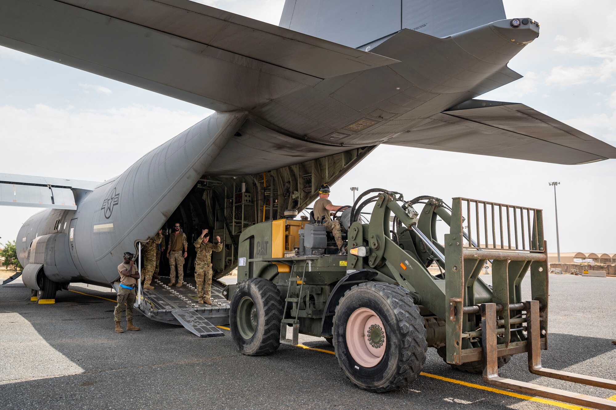 U.S. Air Force Airmen from the 386th Expeditionary Logistics Readiness Squadron and the 40th Expeditionary Airlift Squadron load a forklift on a C-130J Super Hercules during Operation Agile Marauder 23.1 at Ali Al Salem Air Base, Kuwait, May 11, 2023.