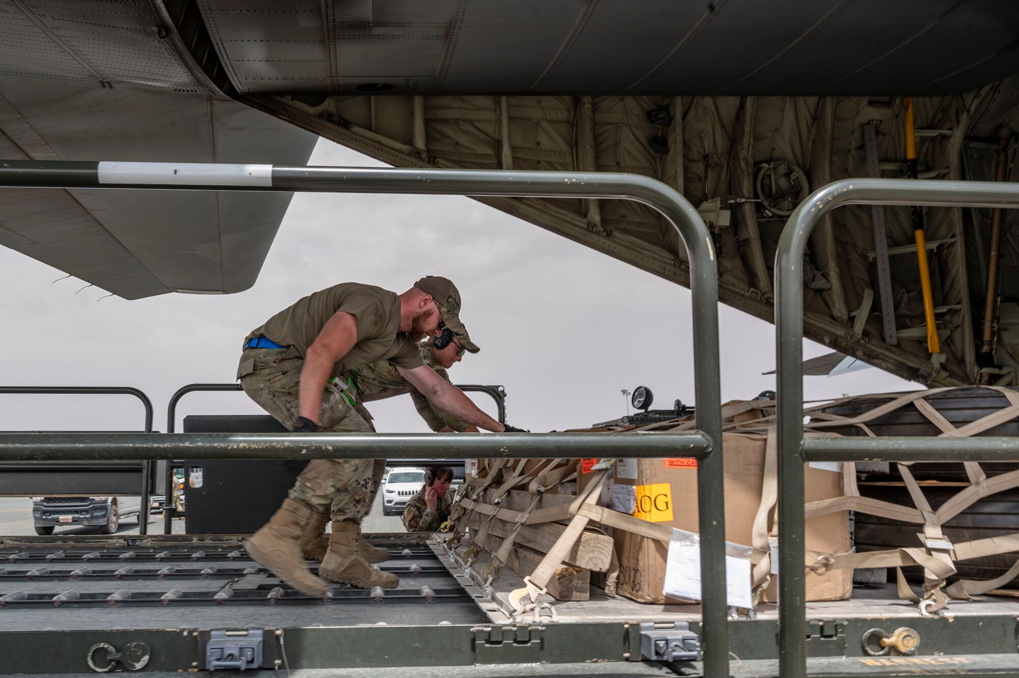 U.S. Air Force Staff Sgt. Trevor Pepin, left, a 386th Expeditionary Logistics Readiness Squadron ramp service technician, and Staff Sgt. Elvis Makepeace, a 386th ELRS load team chief, push a pallet of supplies onto a C-130J Super Hercules during Operation Agile Marauder 23.1 at Ali Al Salem Air Base, Kuwait, May 11, 2023.