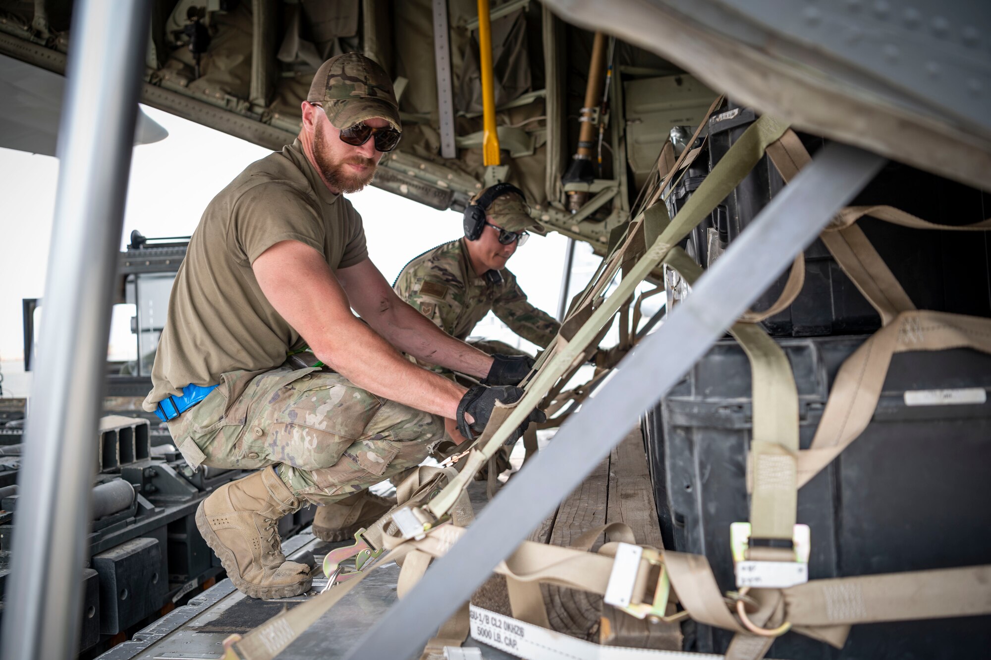 U.S. Air Force Staff Sgt. Trevor Pepin, left, a 386th Expeditionary Logistics Readiness Squadron ramp service technician, and Staff Sgt. Elvis Makepeace, a 386th ELRS load team chief, push a pallet of supplies onto a C-130J Super Hercules during Operation Agile Marauder 23.1 at Ali Al Salem Air Base, Kuwait, May 11, 2023.