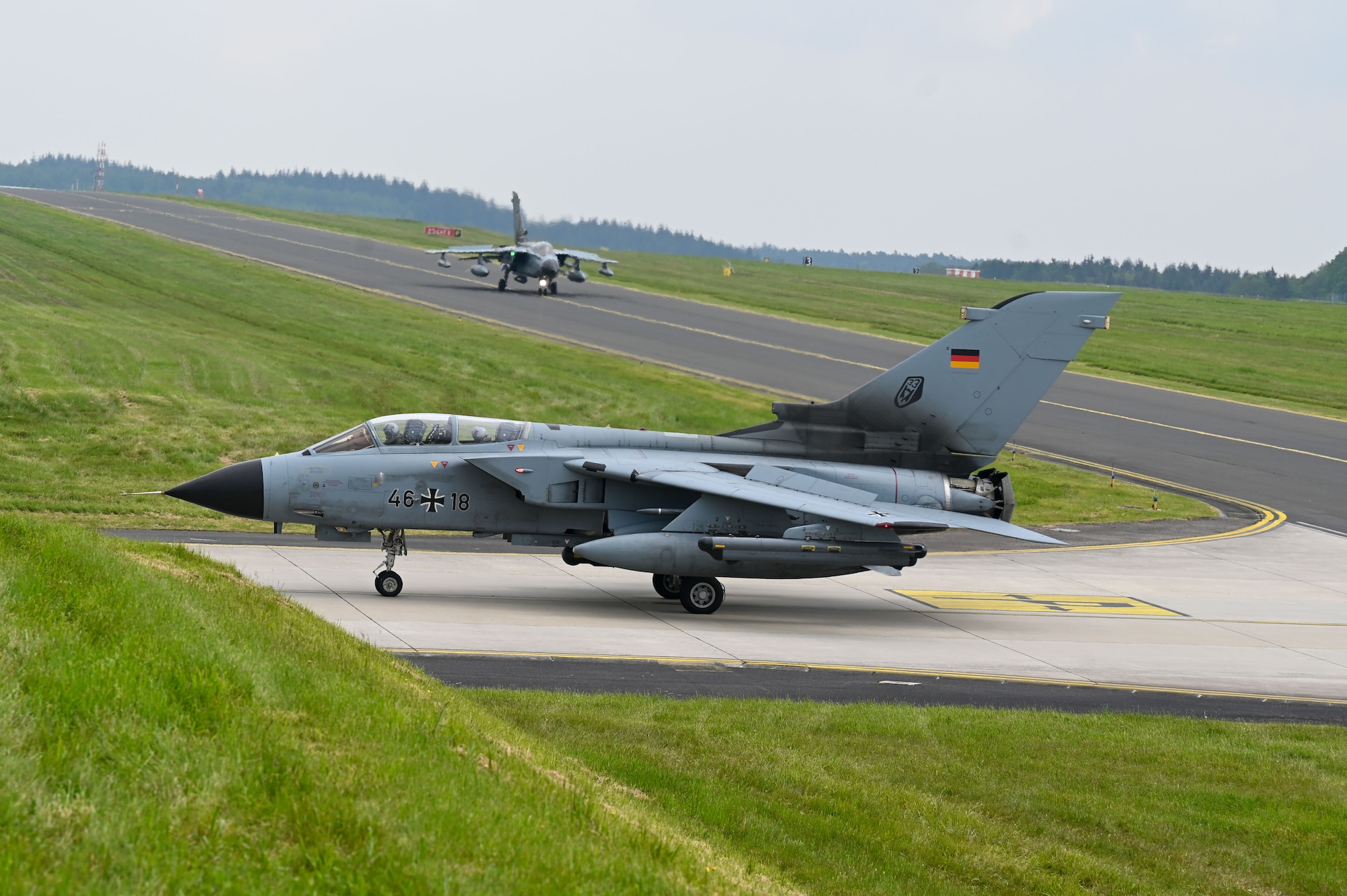 Two German Air Force PA-200 Tornado aircraft assigned to Tactical Air Wing 33, Büchel Air Base, Germany, taxi at Spangdahlem AB, Germany, May 15, 2023. The Tornado aircraft will be stationed at Spangdahlem AB, providing the opportunity for bilateral training flights between the 52nd Fighter Wing and the 33rd Tactical AW. (U.S. Air Force photo by Senior Airman Jessica Sanchez-Chen)