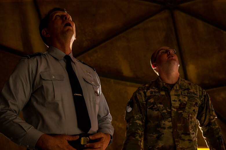 VCSO looks up at radome alongside a guardian.