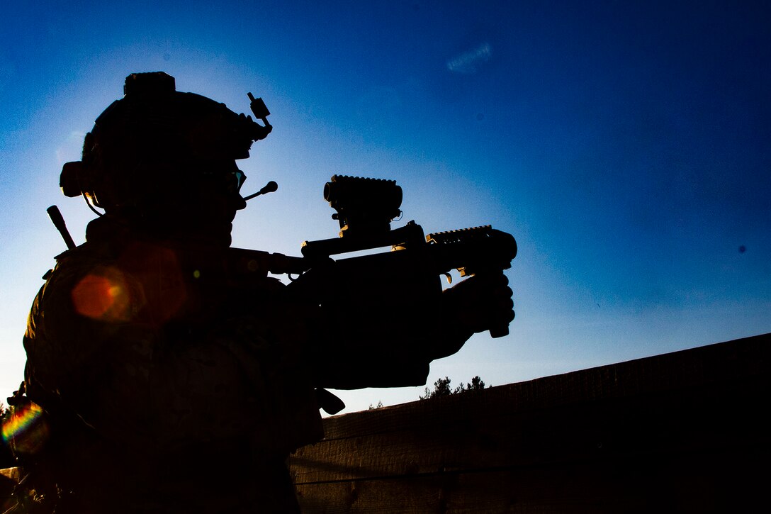 A soldier is shown in silhouette, holding a grenade launcher.