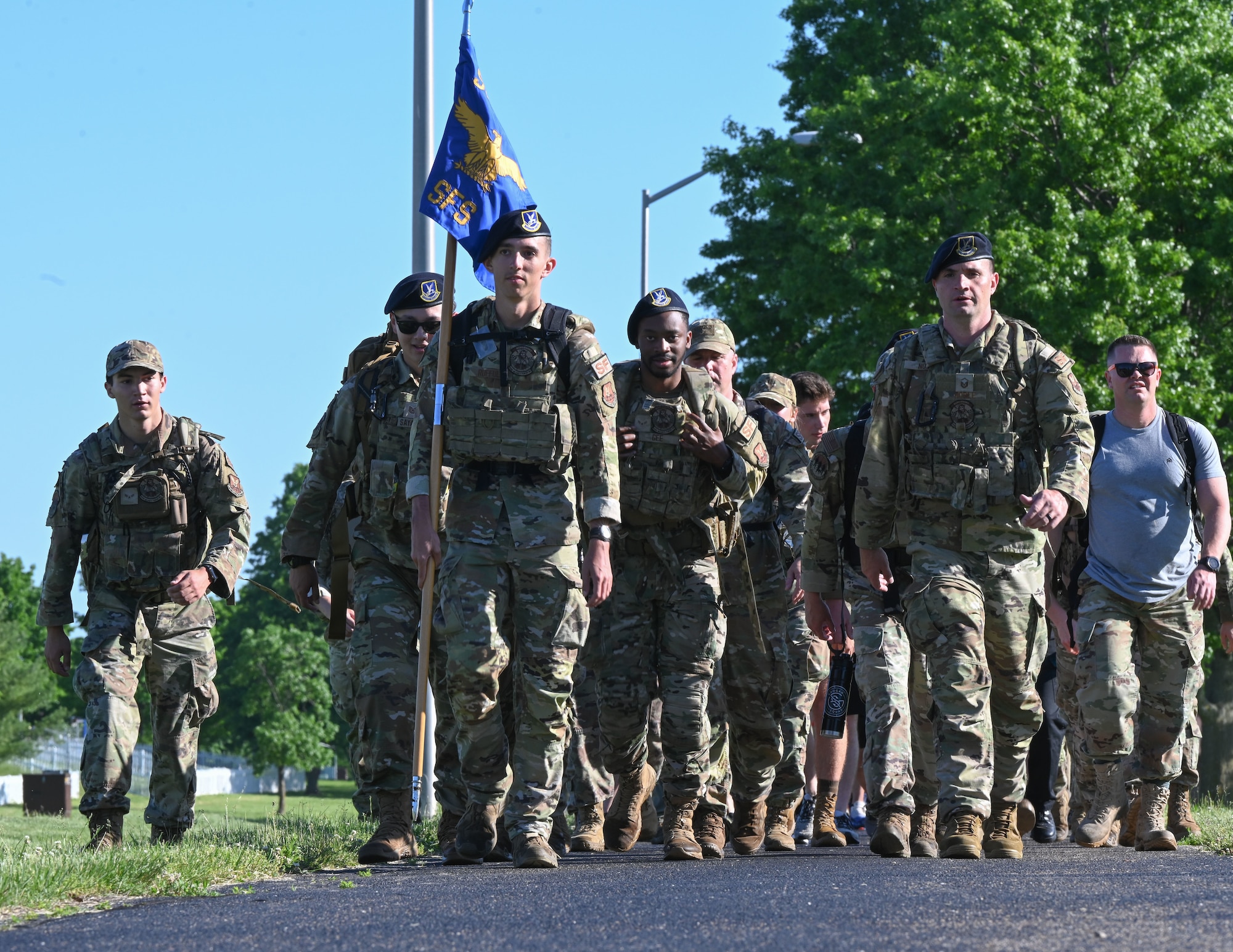 Members of the 509th Bomb Wing ruck during the annual police week memorial ruck march on Whiteman Air Force Base, Mo., May 16, 2022. Participants rucked four miles stopping at eight different stations to honor fallen defenders, doing various exercises at each station. (U.S. Air Force photo by Airman 1st Class Bryson Britt)