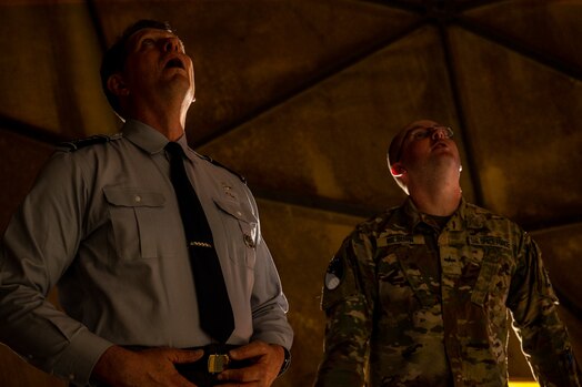  VCSO looks up at radome alongside a guardian.