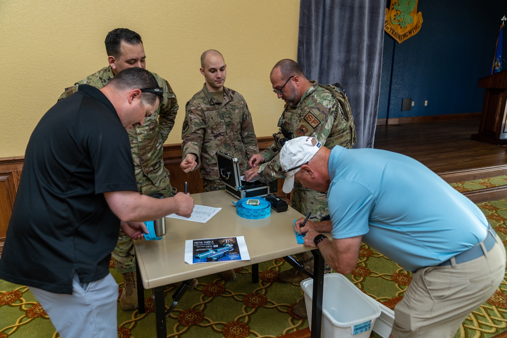 Members from the 81st Security Forces Squadron sign in police officers to play a round of golf before the opening ceremony for National Police Week at Keesler Air Force Base, Mississippi, May 15, 2023.