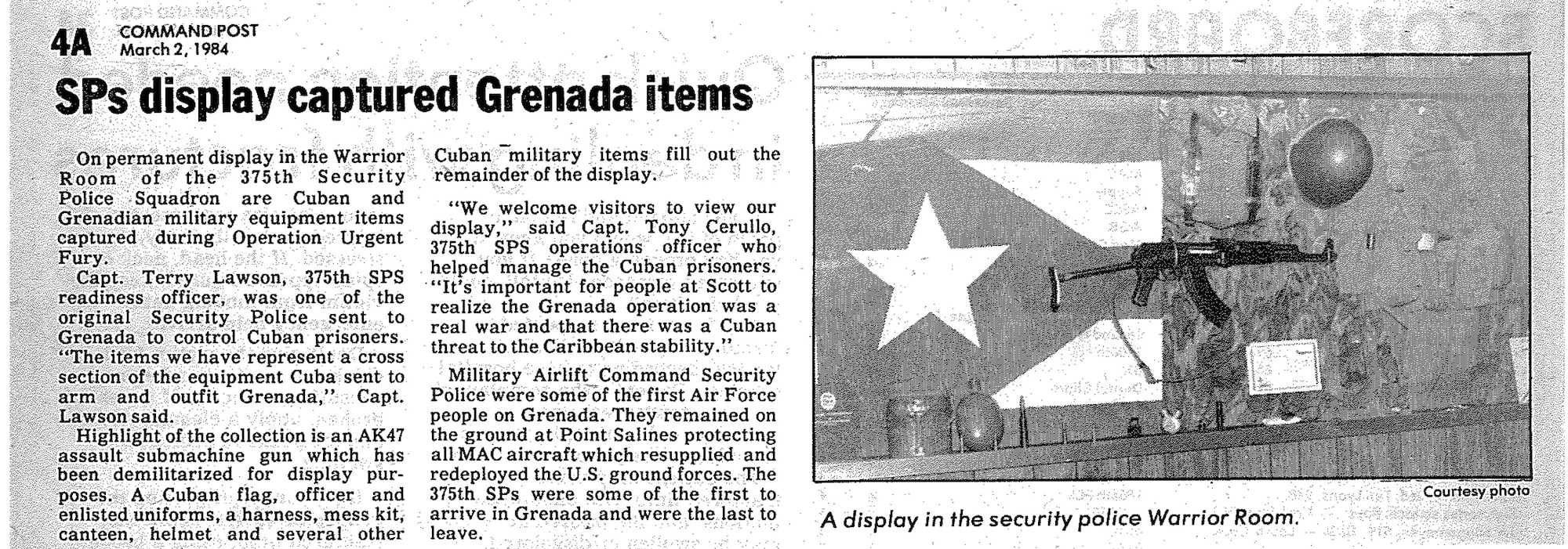 An article from the Scott newspaper about captured items from Operation URGENT FURY displayed at the 375th Security Police Squadron building in 1984.  (375th Air Mobility Wing Historical Archives)